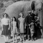 Joan Bayley, Ann Saunders, Fay Bayley and Bob Bayley with a passing circus elephant and keeper at Smithbrook in about 1947