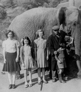 Joan Bayley, Ann Saunders, Fay Bayley and Bob Bayley with a passing circus elephant and keeper at Smithbrook in about 1947